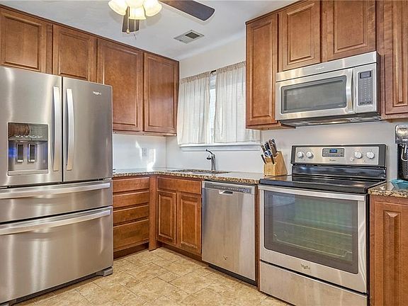 Updated kitchen with new refrigerator and granite countertops