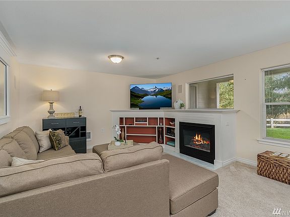 Open living room with a wall of windows and natural light.
