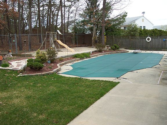In ground pool in landscaped/fenced private area.