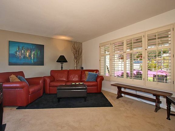 Spacious living room features built-in blinds.