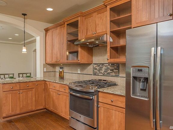 Stainless appliances and eat-at counter in chef's dream kitchen.