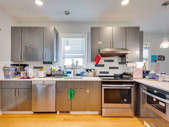 Stainless steel appliances, including a microwave drawer, glass-top stove, designed with kid-friendly safety in mind