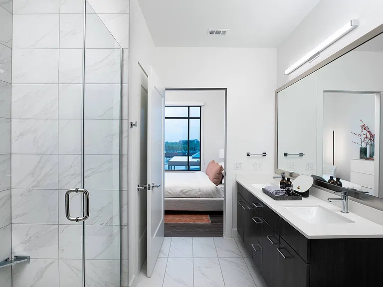 Porcelain Carrara tile walls & floors create a luxurious ambiance.