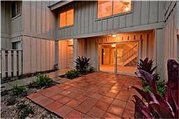 Front porch area just off living room allows plenty of natural light to shine in while affording plenty of privacy
