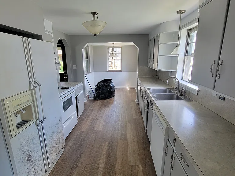 Kitchen from dining room, with fresh flooring and breakfast nook