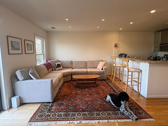 Another view of living room on main level. Open kitchen in the right of the photo.