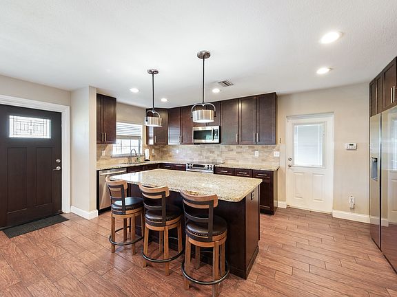 Kitchen with granite countertops and stainless steel appliances.