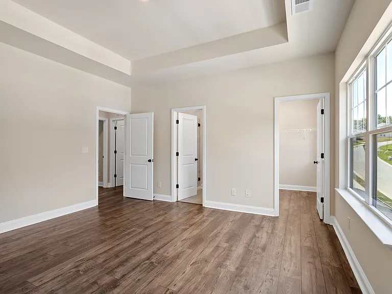 Primary bedroom with 2 walk-in closets