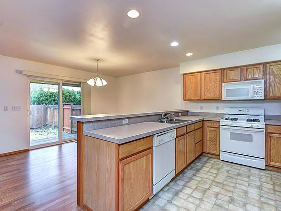 Open kitchen with plenty of storage with eating area.