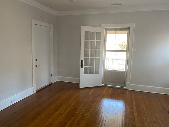 The living room. (Some people have used this as the bedroom & it's works really well like that!) 
The closed door is the internal stairwell. The glass door opens to your balcony.
