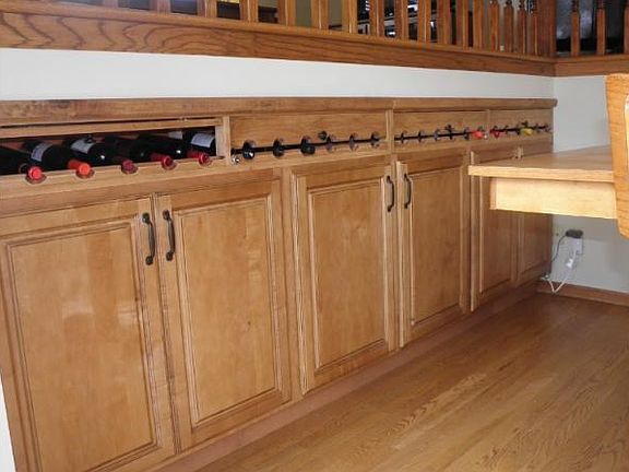 Custom locking and lighted wine rack above new cabinets