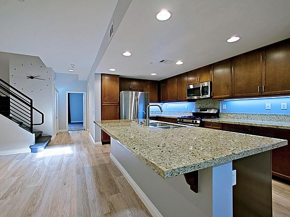 Spacious kitchen with large center island, pull-out organizers by "Simple Human", reverse osmosis water filtration & stainless appliances with refrigerator included.