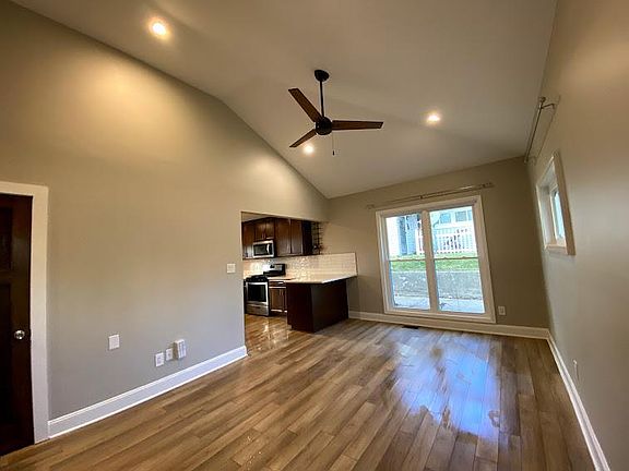 Living room area is open to the kitchen. There is an overhang of the countertops for barstools on the peninsula.