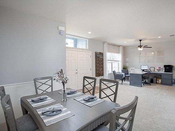 Versatile den and dining room located off the foyer - Photos from a home with similar finishes, not