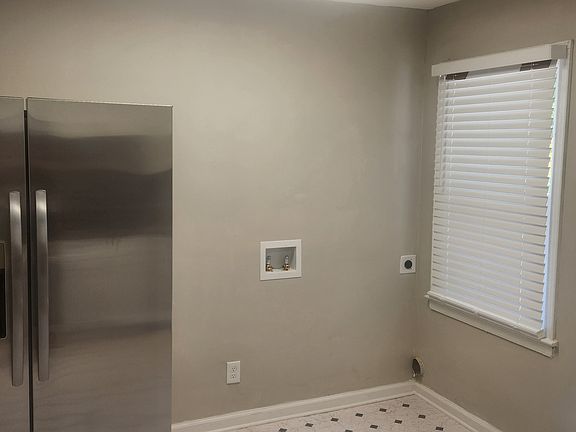 Kitchen including stainless steel appliances. Washer/dryer connection.