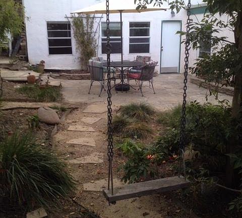 Back of house, garden and swing.