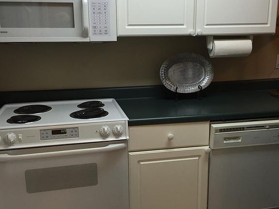 Kitchen with stove, fridge, and microwave