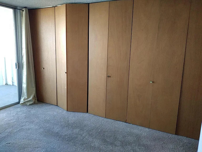 Closets in Master bedroom with sliding glass door to balcony