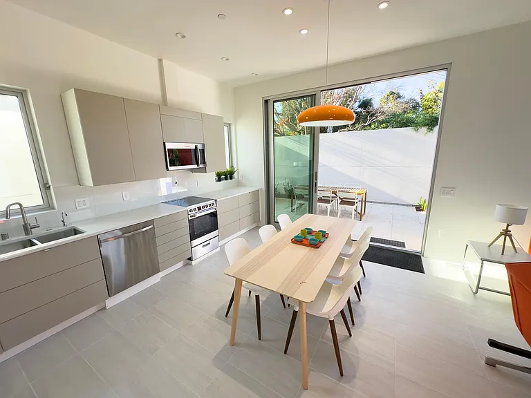 The kitchen easily accommodates 8 chairs. The indoor-outdoor relationship is superb.