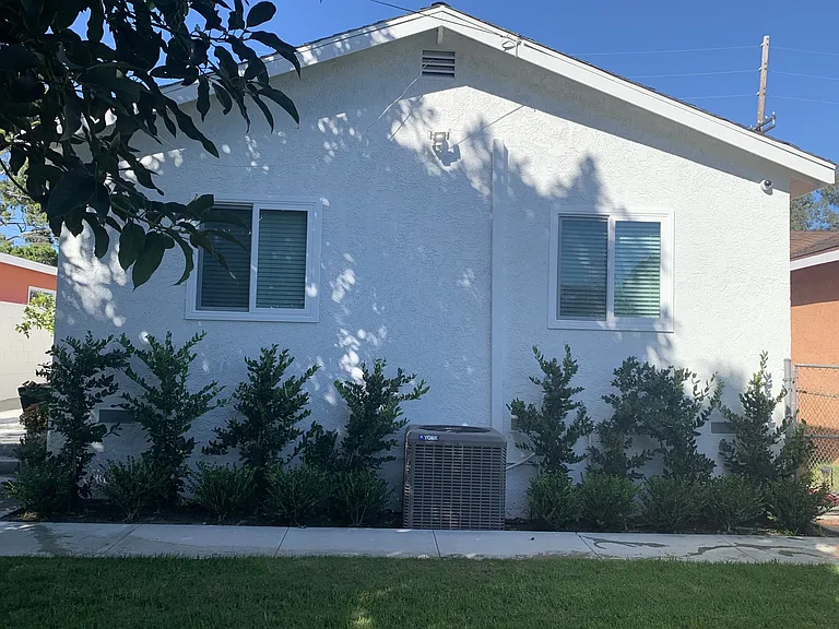 Well-maintained rear exterior featuring fresh stucco, updated windows and low maintenance landscaping.
