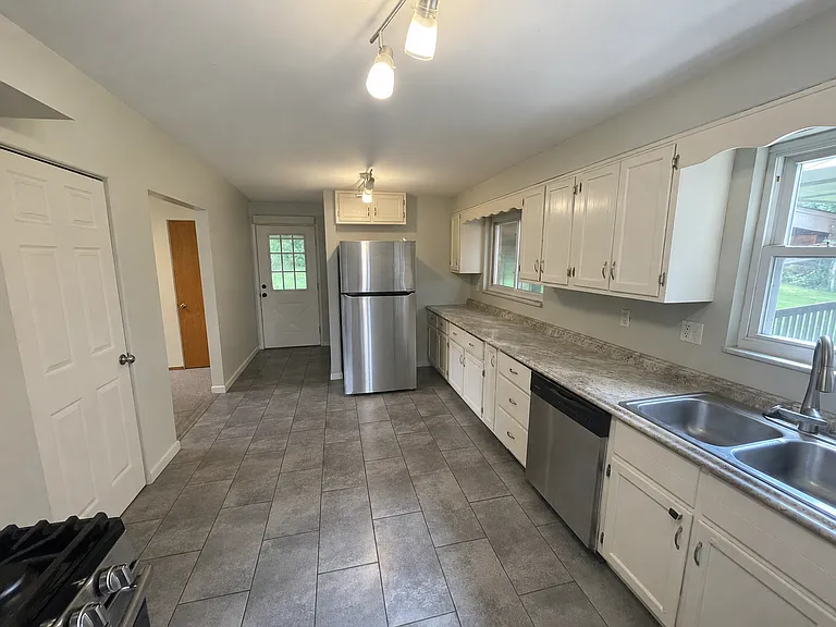 Kitchen w/ wide entry door from carport