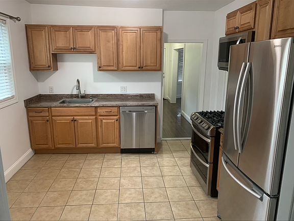 Bright eat in kitchen with SS appliances including a massive gas convection double oven, over-the-range microwave, french door fridge and dishwasher. Laundry off kitchen.