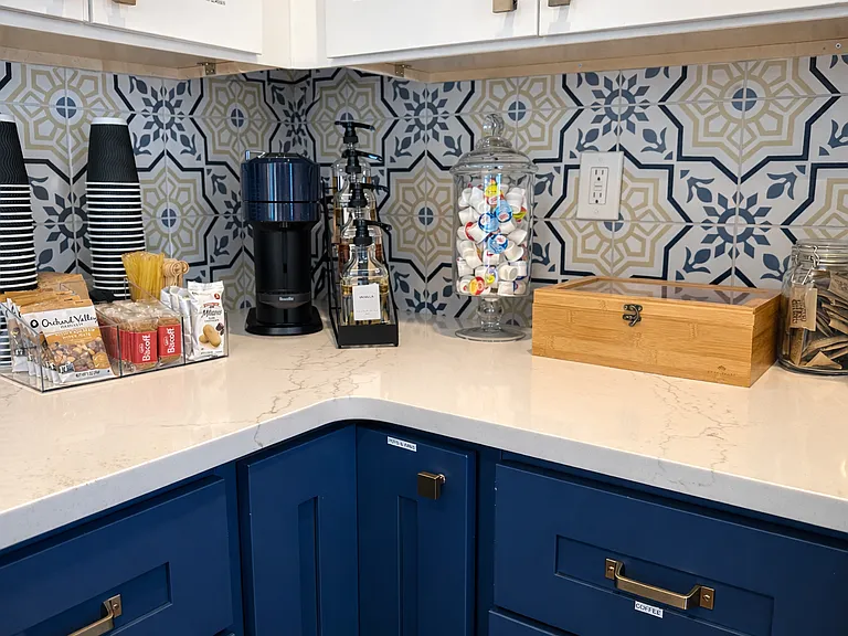 Luxe espresso bar equipped for coffee, espresso, or tea. Snack bar stocked with cookies and tea treats, plus honey, creams, and sweeteners to elevate every luxurious cup of sunshine.