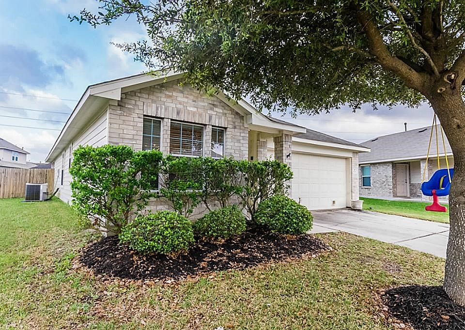 Charming home with beautiful landscaping greeting you in the front.