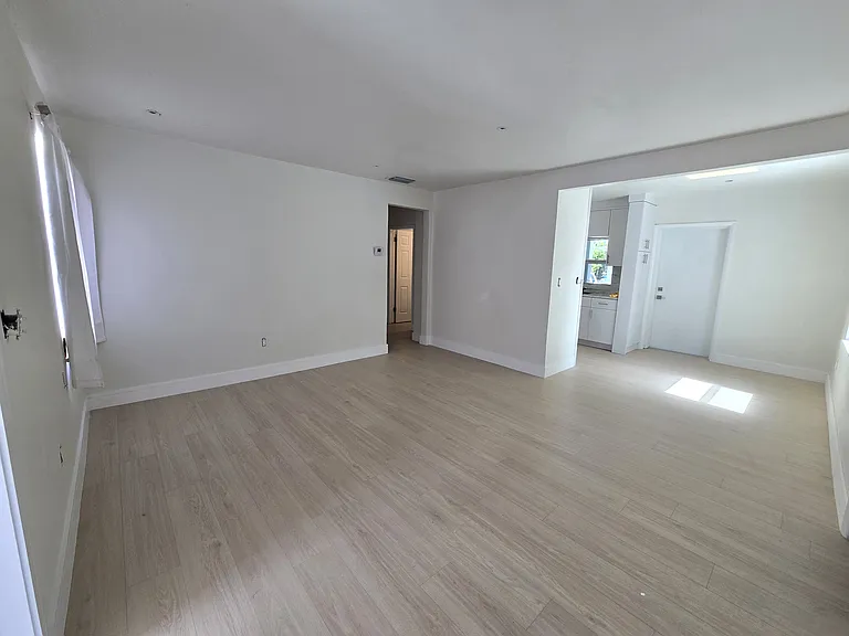 This spacious home has been newly and completely renovated with bedrooms to either side of the main living area