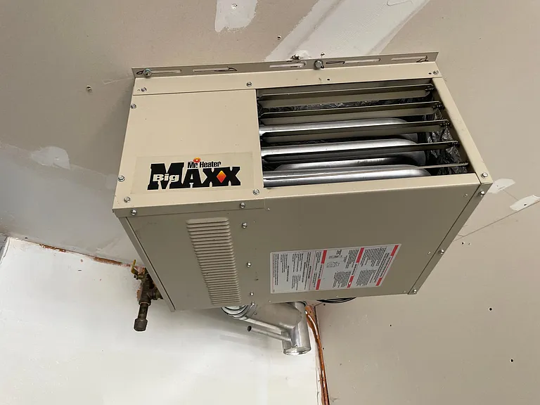 The garage has a heater that may be used to warm the garage in the winter.