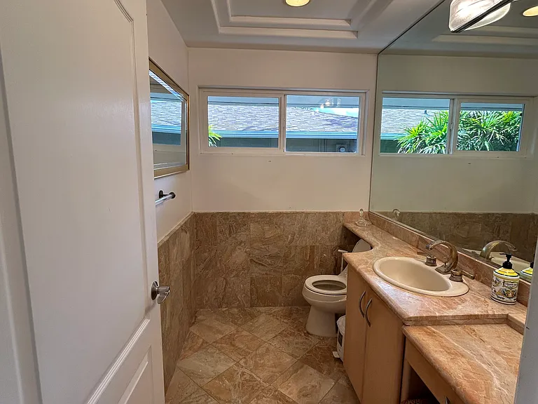 Half bath with marble finishes located near 5th bdrm & Office