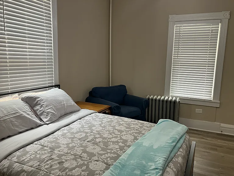 Large, fully furnished first bedroom that can serve as an office or den.