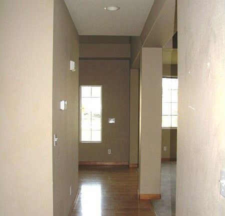 Hallway with Hardwood Floors leading Past Formal Living and Dining Rooms