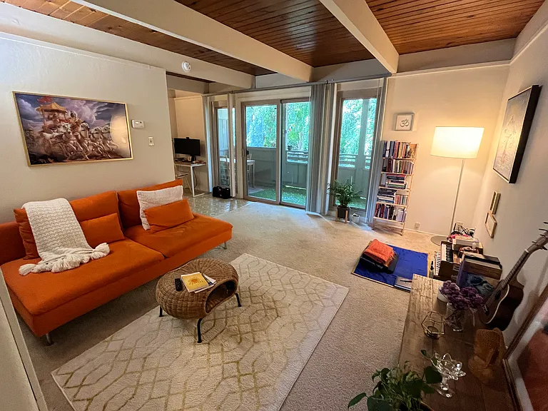 Living room looking out over nature and trees and a private covered deck (Large 1 BR upstairs).