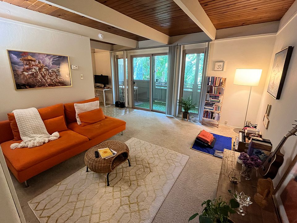 Living room looking out over nature and trees and a private covered deck (Large 1 BR upstairs).