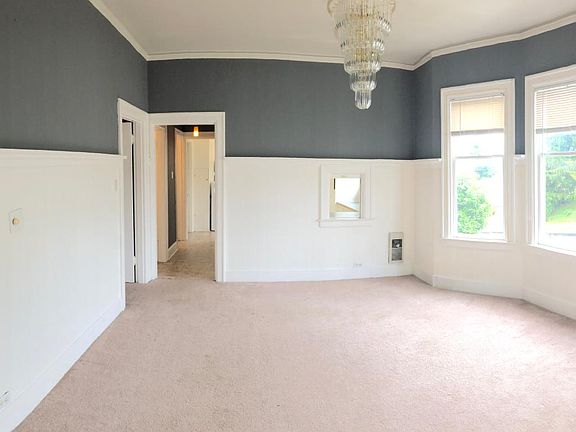 Dining Room with lots of natural light - door/hallway on left comes from the entrance, door/hallway at end of the room leads to bedrooms, bathroom and kitchen.