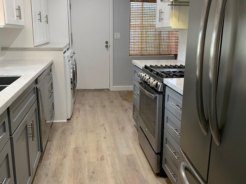Updated kitchen with side door for convenient BBQ meals.