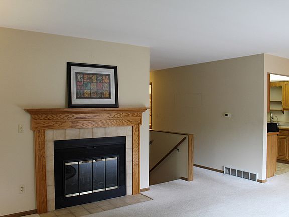 The wood burning fireplace adds a nice touch to the cozy living area.
