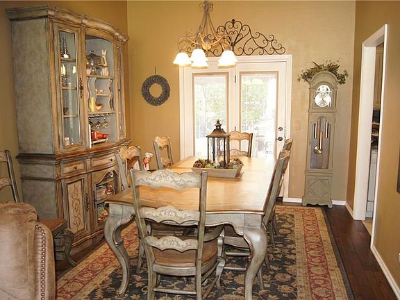 Dining area features double french doors overlooking beautiful back yard with access to kitchen