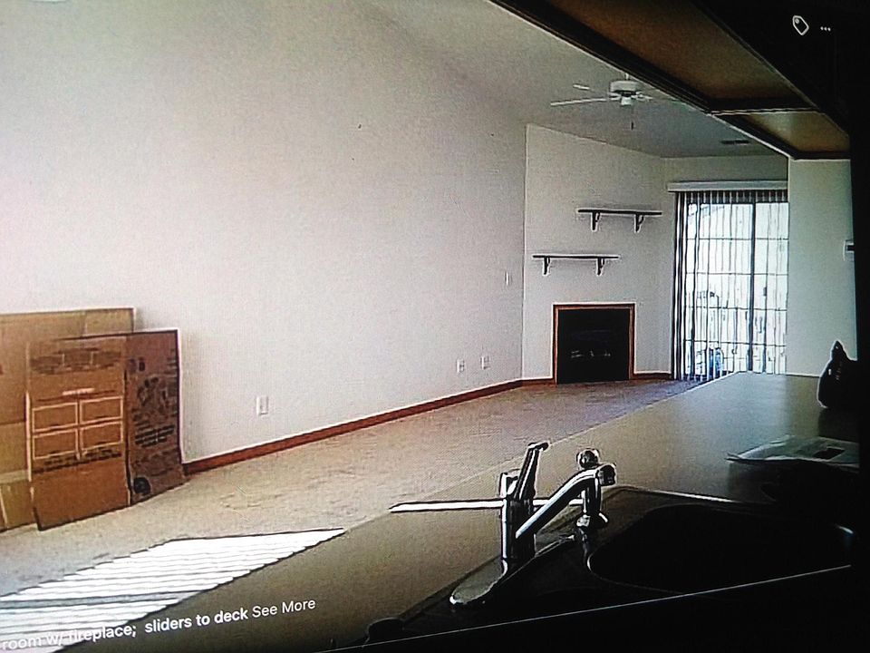Living/dining w/fireplace ; doors to balcony.