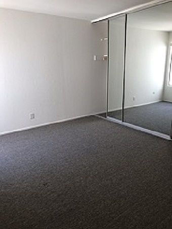 Bedroom with mirrored sliding closet doors