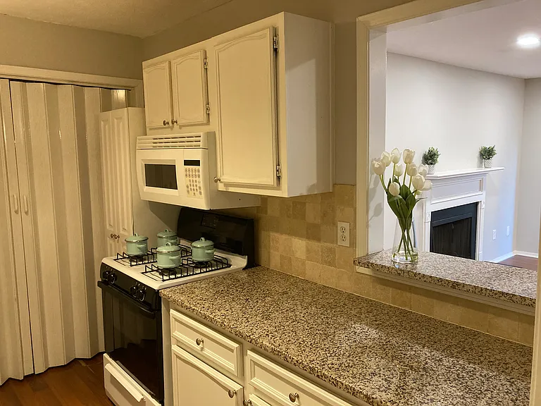 Kitchen with granite countertop and an opening to the Livingroom