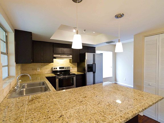 Granite Counters with Tumbled Travertine Backsplash