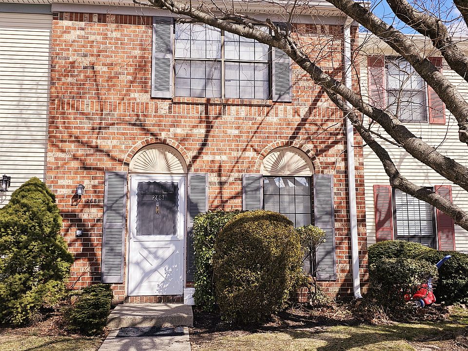 Front entrance with well maintained shrubbery and garden like setting