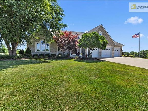 Lots of beautiful landscaping and pretty green lawn.
