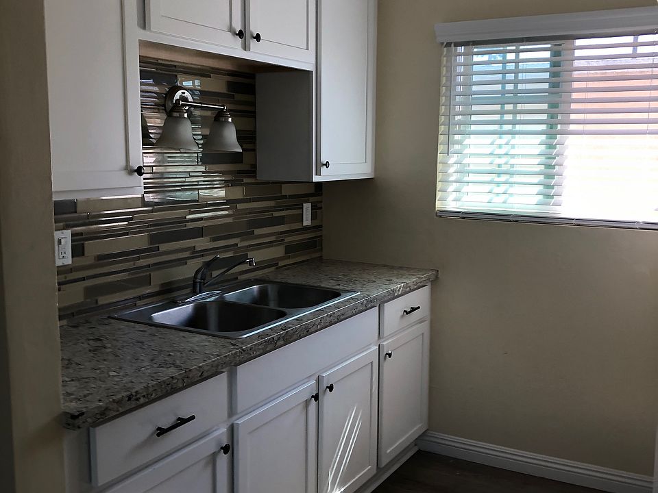 Newly installed kitchen Cabinets with stainless steel sink, splash wall and quartz countertop.