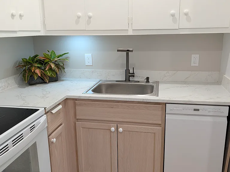 Kitchen equipped with dishwasher, 1.25 hp disposal, multi spray faucet, easy clean glass cooktop and oven, refrigerator, new ceiling exhaust fan, bright lights, microwave, area to sit with your computer.