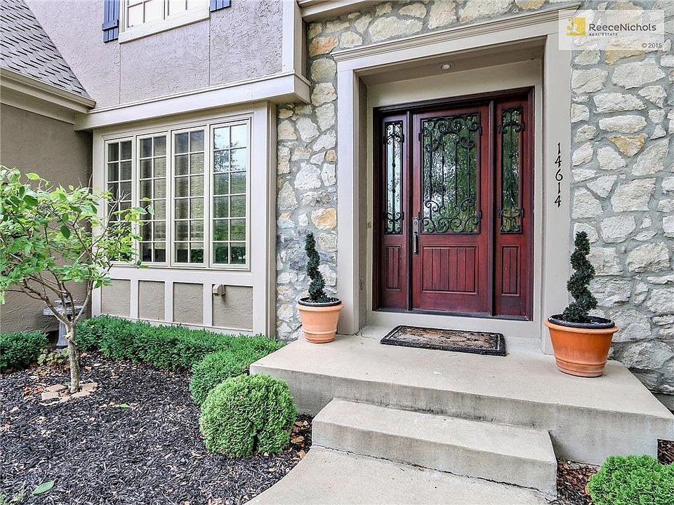 14614 Grandview - WELCOME! Beautiful stone entry with wrought iron detailed door and side lights.