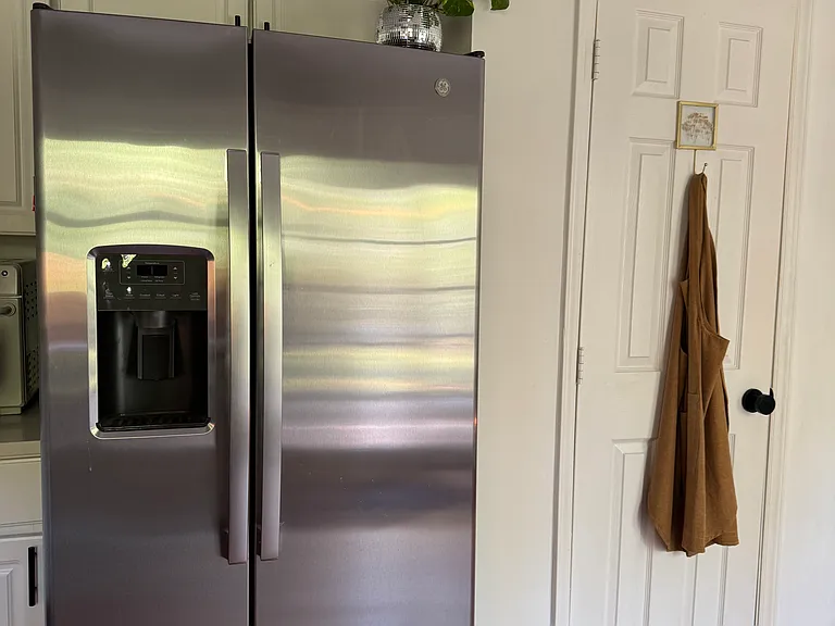 Kitchen - stainless steal fridge/freezer, large pantry to the right of fridge.