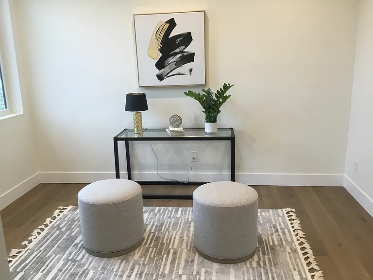 Versatile main-level room ideal for a private office, quiet retreat, guest space, fitness room, or additional lifestyle living tailored to your needs.